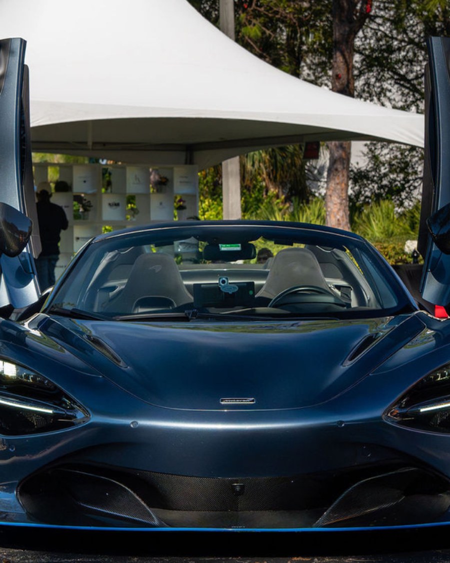 Close-up of a livery Porsche's wheel and hood at a Naples car show